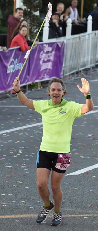 Runner finishing a race, holding a flag.