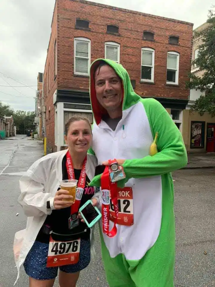 A man in a gator costume poses with a woman.