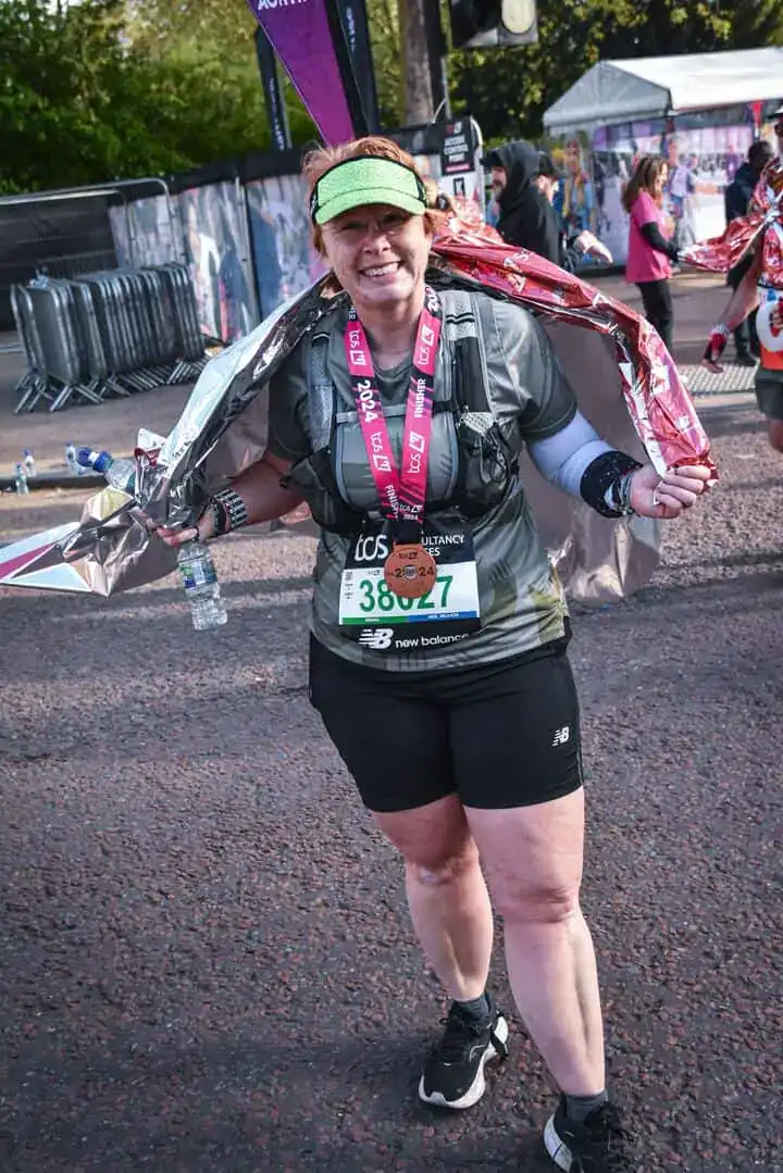 A woman poses after a race.